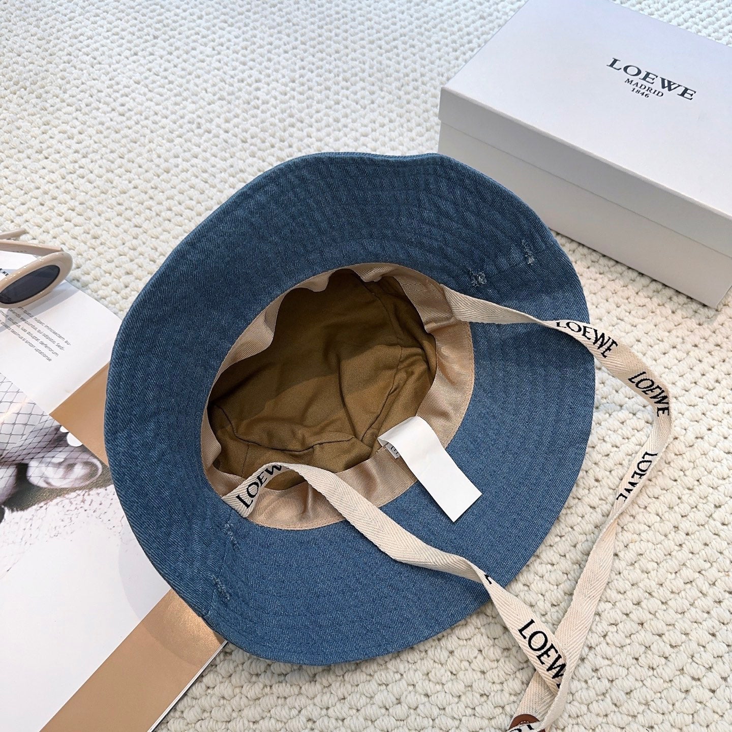Denim bucket hat with embossed patch and detachable strap
